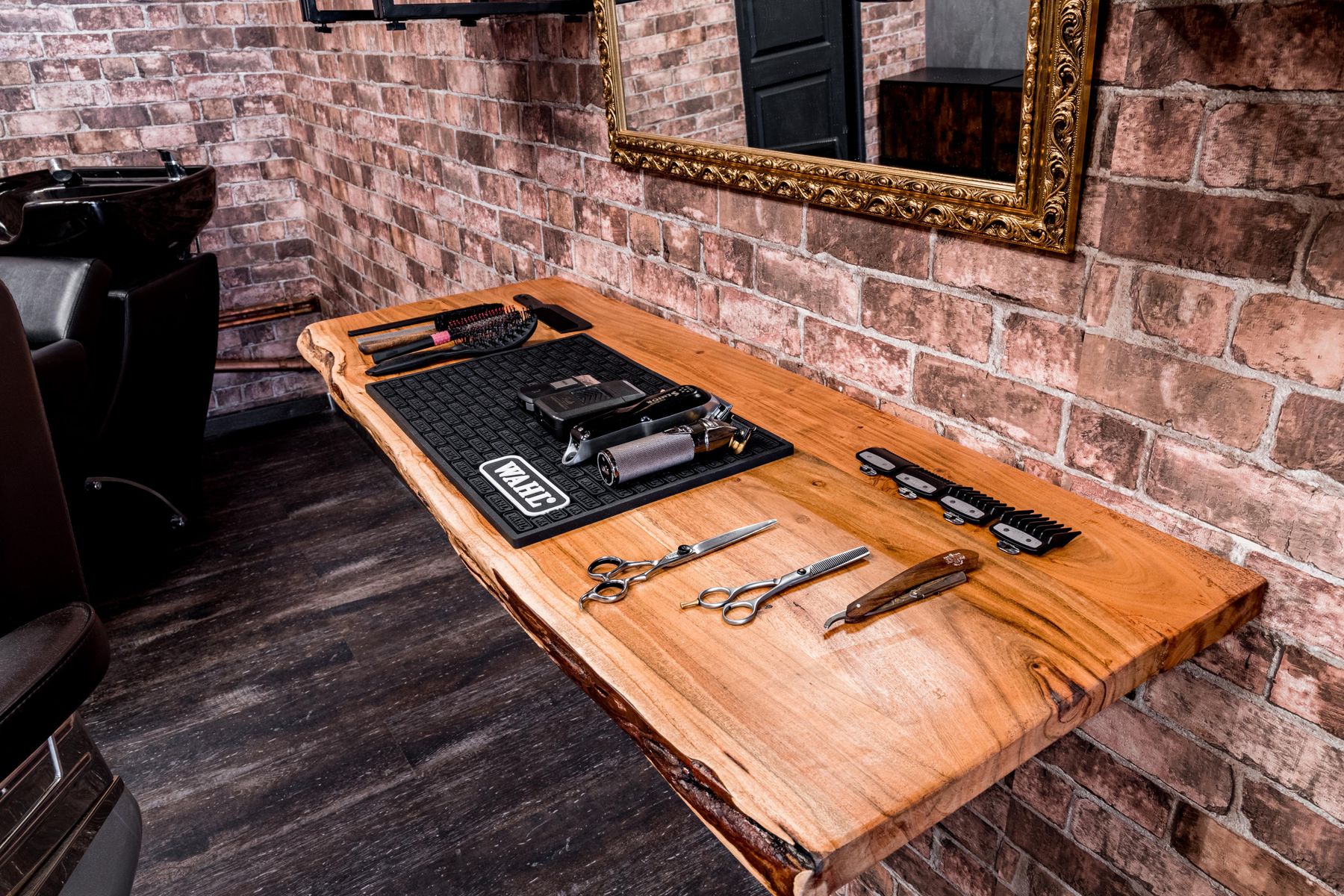 Professional styling tools laid out on a wooden counter